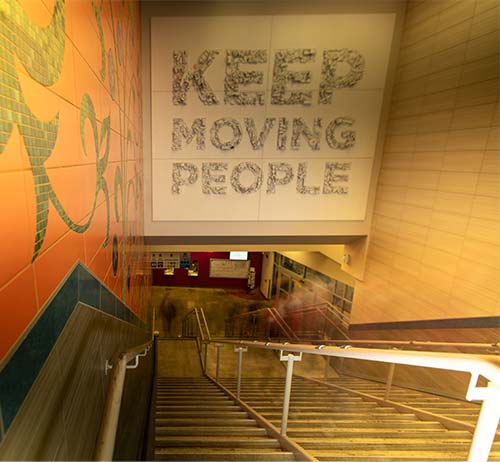 Sign on a bus stairway wall that says "Keep Moving People"